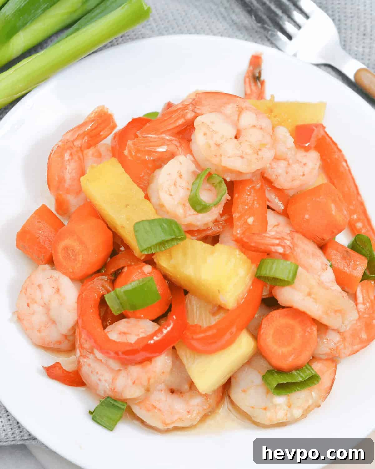A top shot of a plate of the sheet pan shrimp teriyaki and pineapple dinner.
