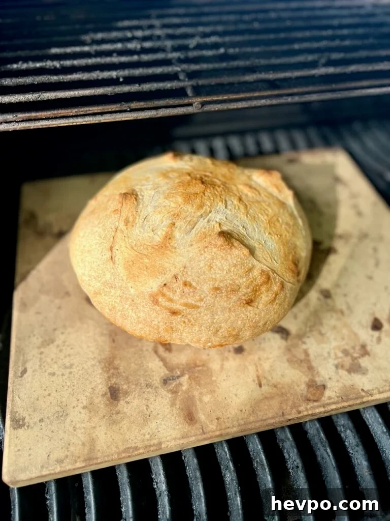 Grilling Sourdough: Step-by-Step Guide to Perfect Crust and Flavor 4 Sourdough bread in the process of being baked on a gas grill
