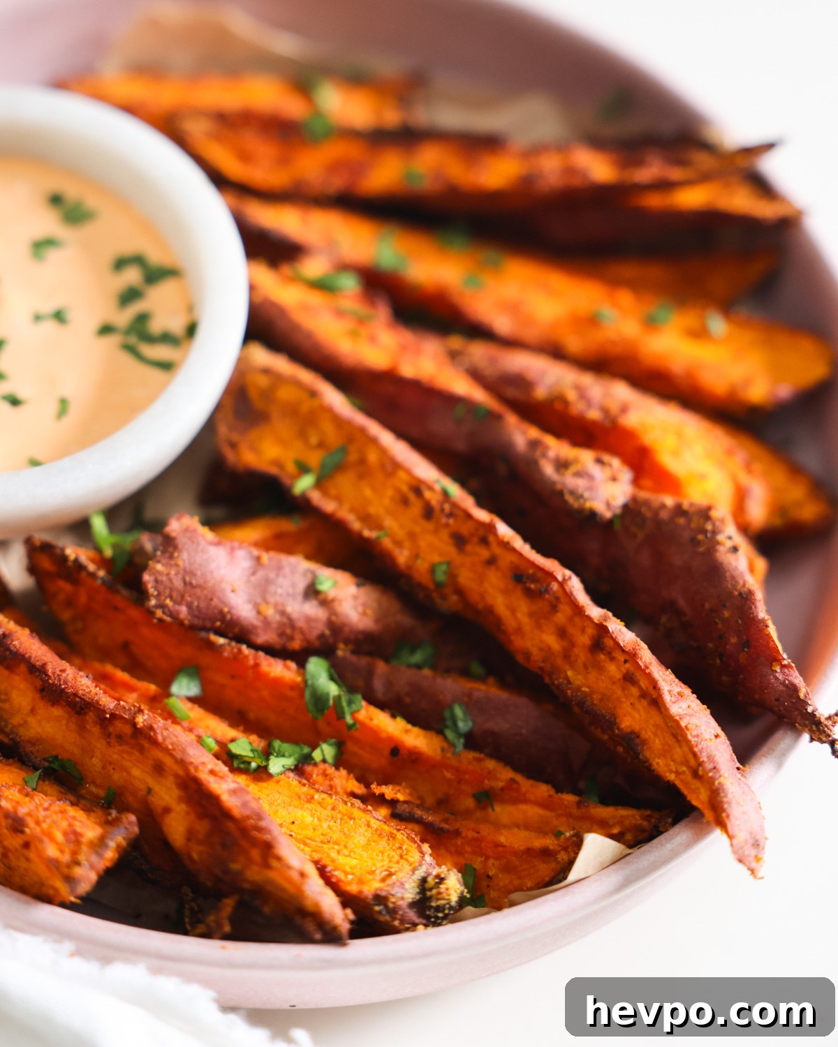 Crispy Air Fryer Sweet Potato Wedges Recipe 8 sweet potato wedges on plate