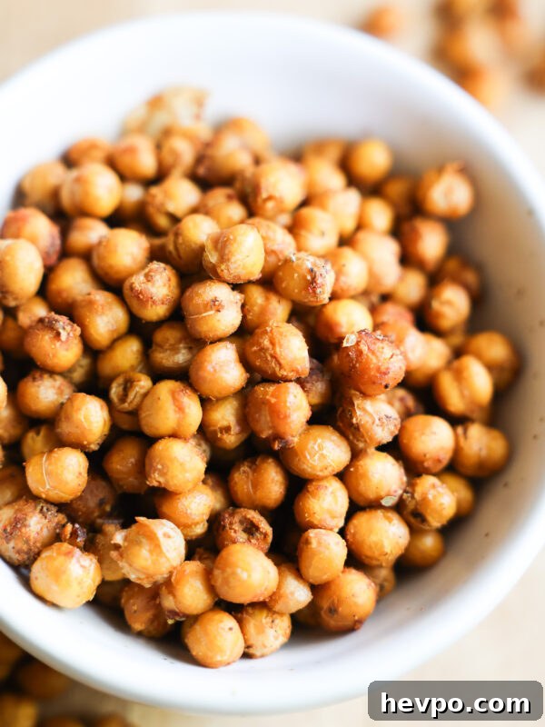 Crispy Air Fryer Sweet Potato Wedges Recipe 11 A close up shot of a white bowl of roasted chickpeas.