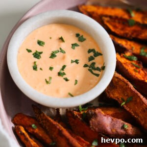 Crispy Air Fryer Sweet Potato Wedges Recipe 14 overhead of gochujang aioli with sweet potato wedges