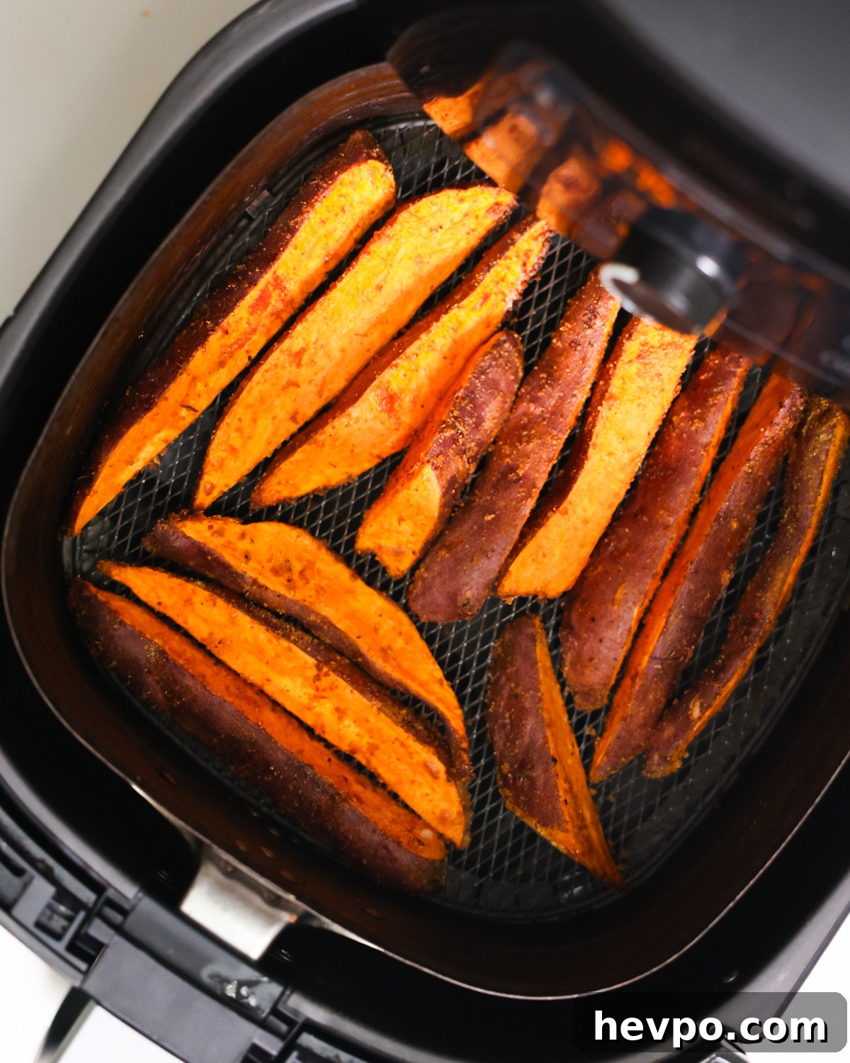 Crispy Air Fryer Sweet Potato Wedges Recipe 7 overhead of air fryer sweet potato wedges in air fryer