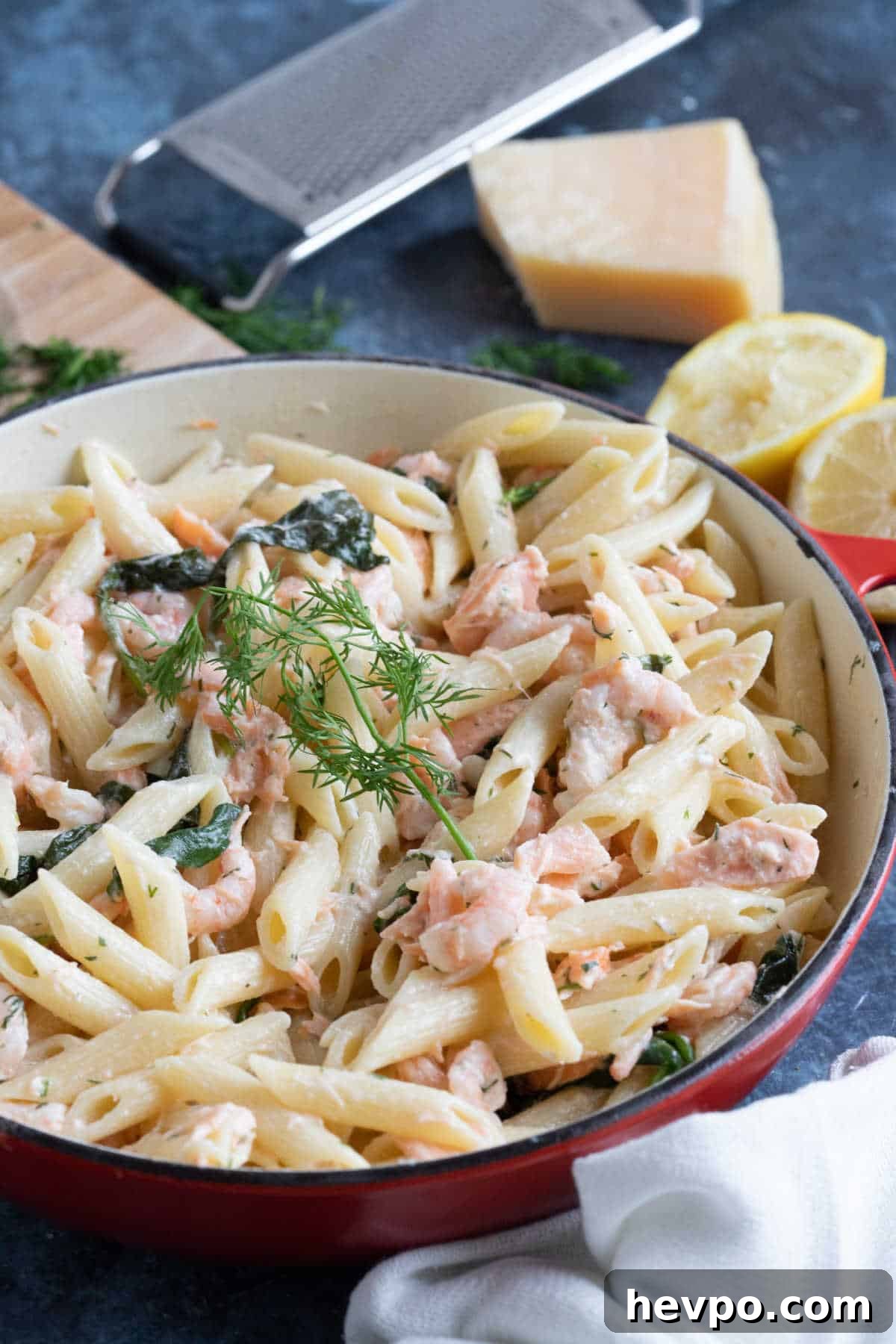 Easy prawn and salmon pasta garnished with dill and lemon.