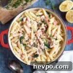 Salmon and prawn pasta with chopped dill on top.