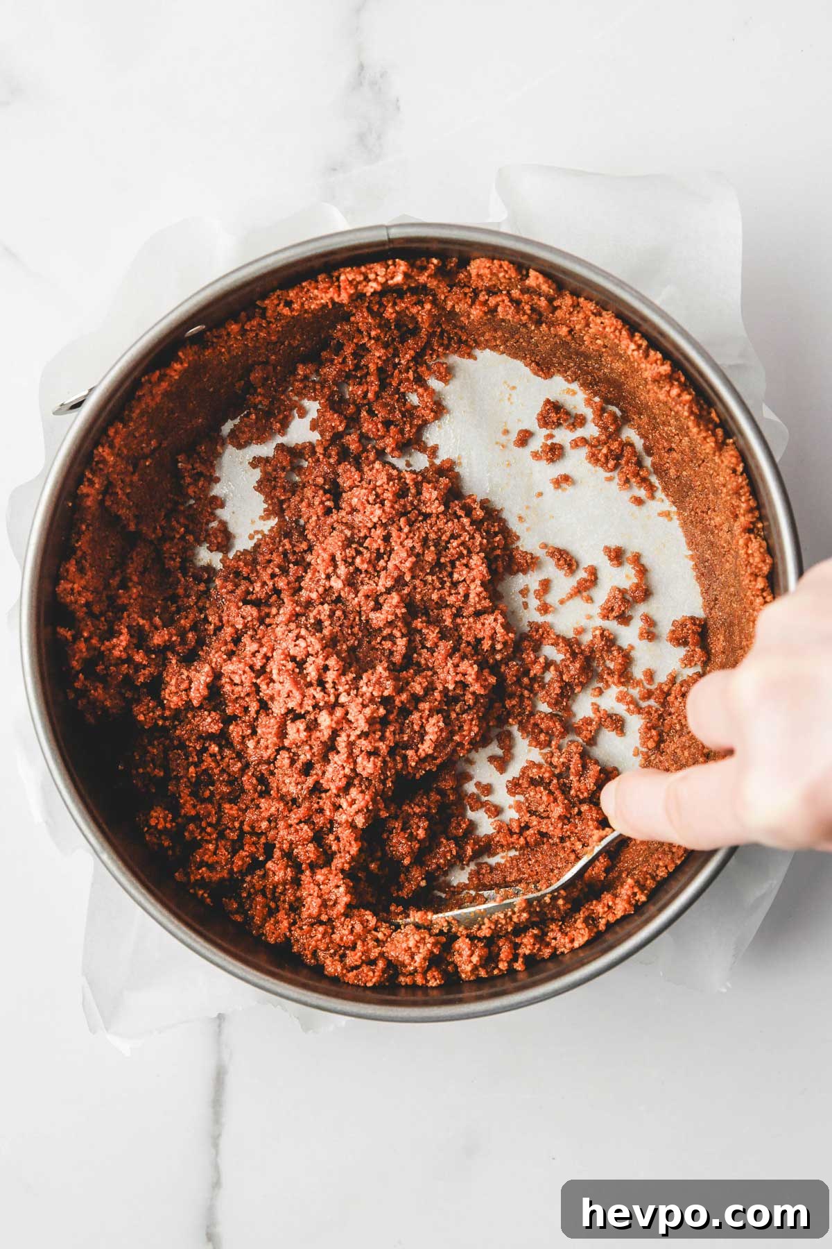 Biscoff Cookie Crust Recipe for Pies & Cheesecakes 5 pressing biscoff crust up the sides of a springform pan