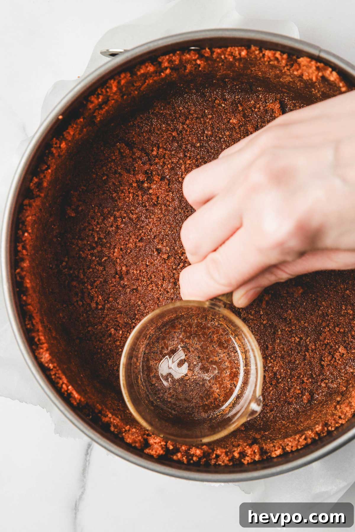 Biscoff Cookie Crust Recipe for Pies & Cheesecakes 7 using a glass to firmly press biscoff crust