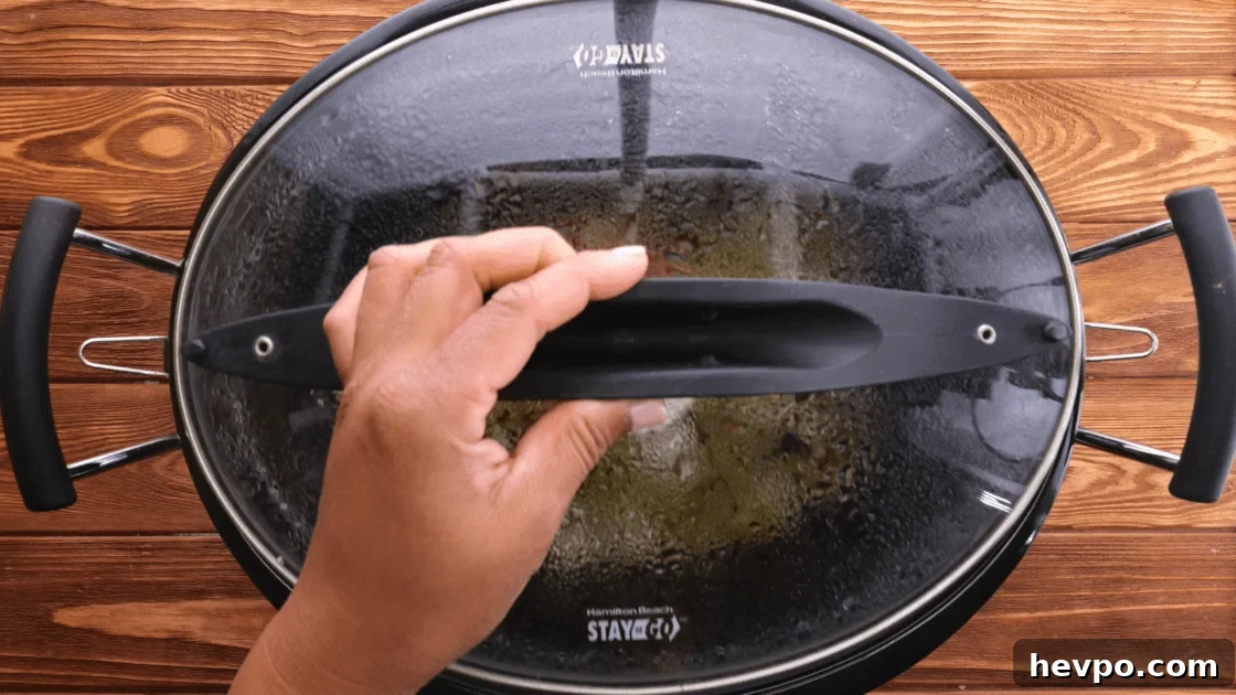 Cover slow cooker and cook.