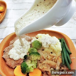 Creamy Honey Mustard Cheese Sauce Recipe 11 Honey mustard sauce being poured from a gravy boat.