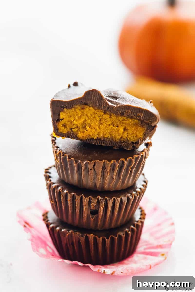 A stack of pumpkin chocolate cups on a table.
