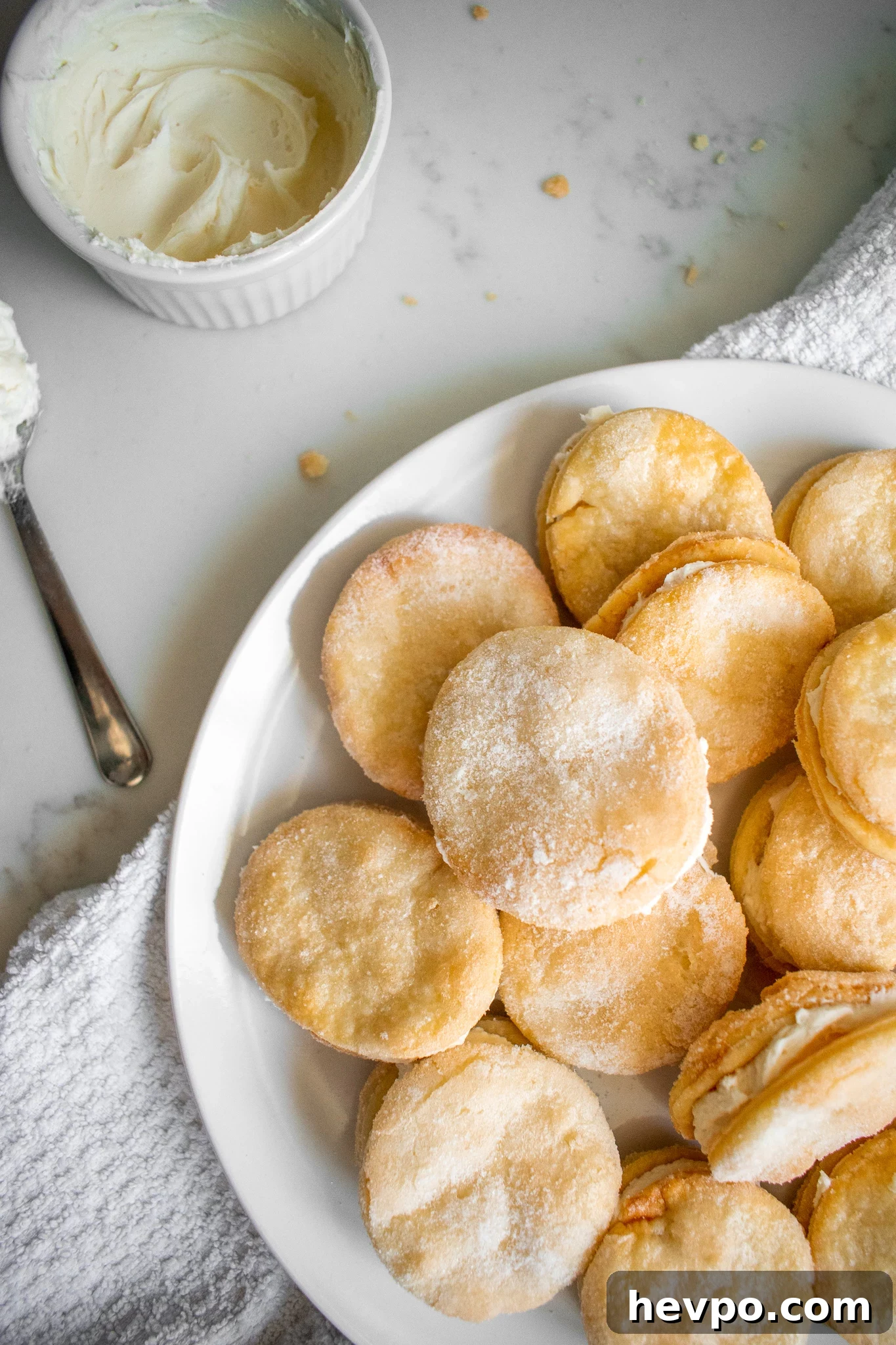 French Waffle Cookies Recipe — Crisp, Buttery Homemade Wafers 2 Sugar sandwich cookies on a plate