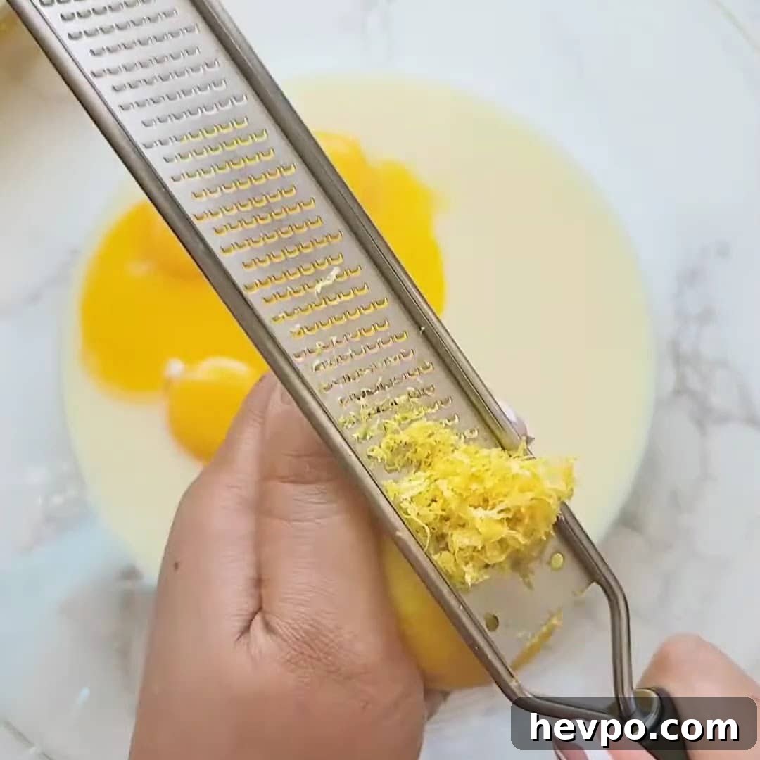 Zesting lemon into creamy filling.