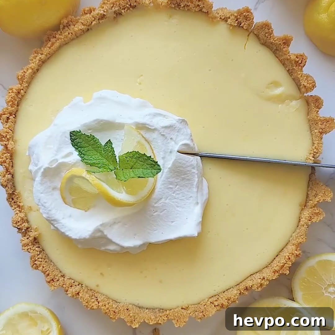 Cutting into a finished lemon icebox pie.