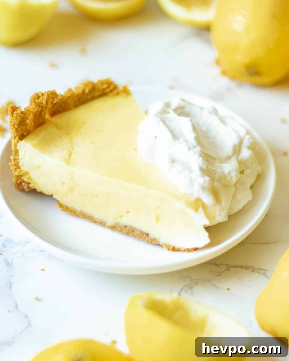 a slice of lemon icebox pie on a plate with whipped cream