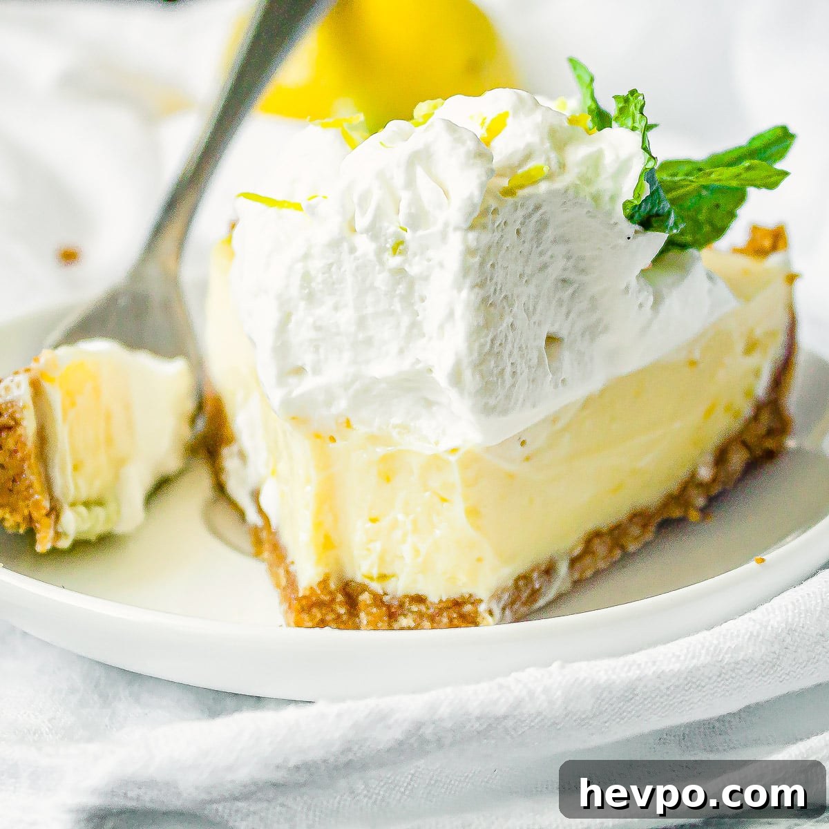 lemon icebox pie on a plate with a bite cut out