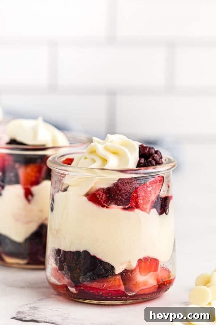 small dish containing keto mousse layered with berries