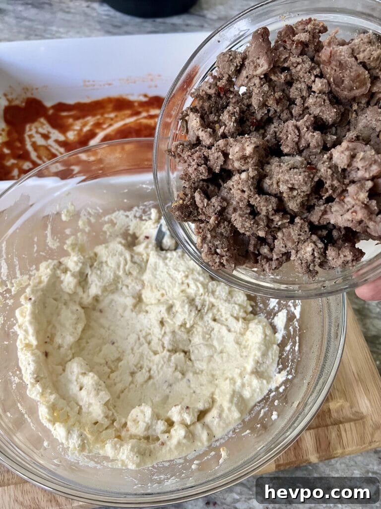 Baked Rigatoni al Forno with Sausage and Beef: Rustic Oven Pasta 9 Adding cooked beef and sausage to the cheese mixture.