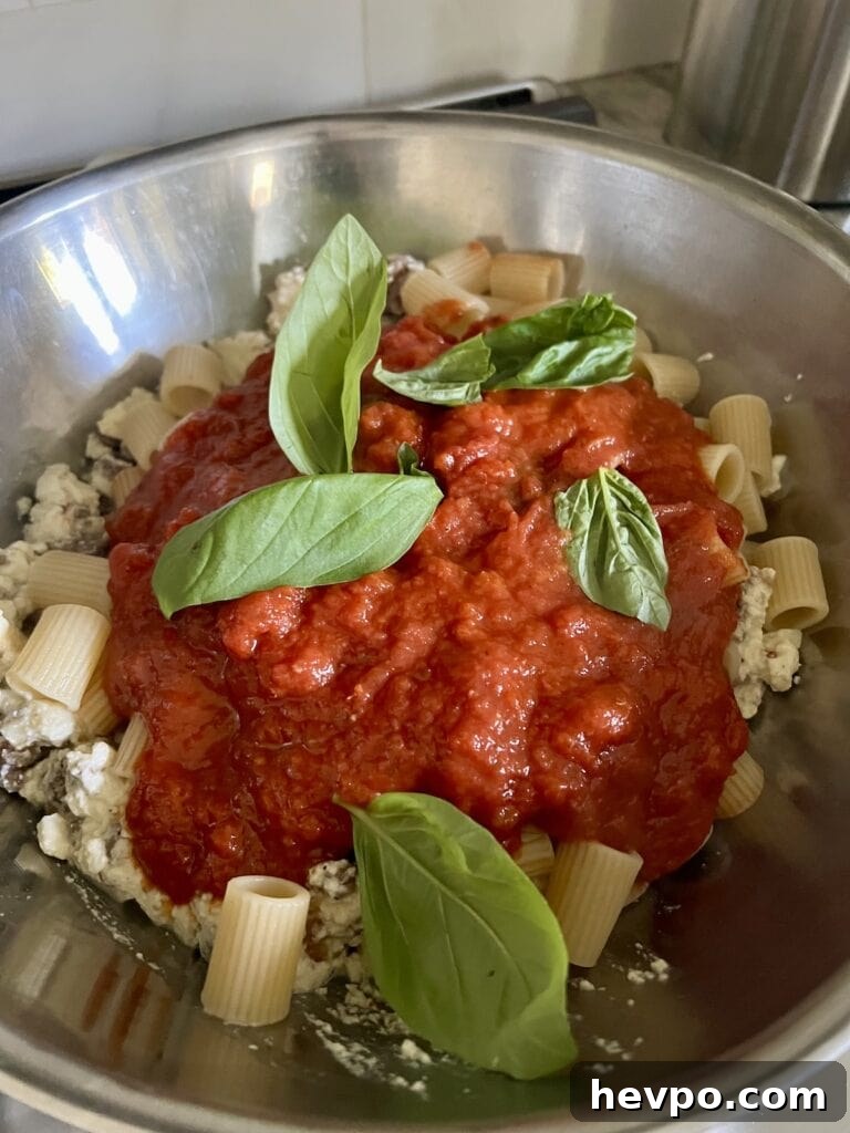 Baked Rigatoni al Forno with Sausage and Beef: Rustic Oven Pasta 10 All ingredients for pasta al forno in a large bowl ready to be mixed together.