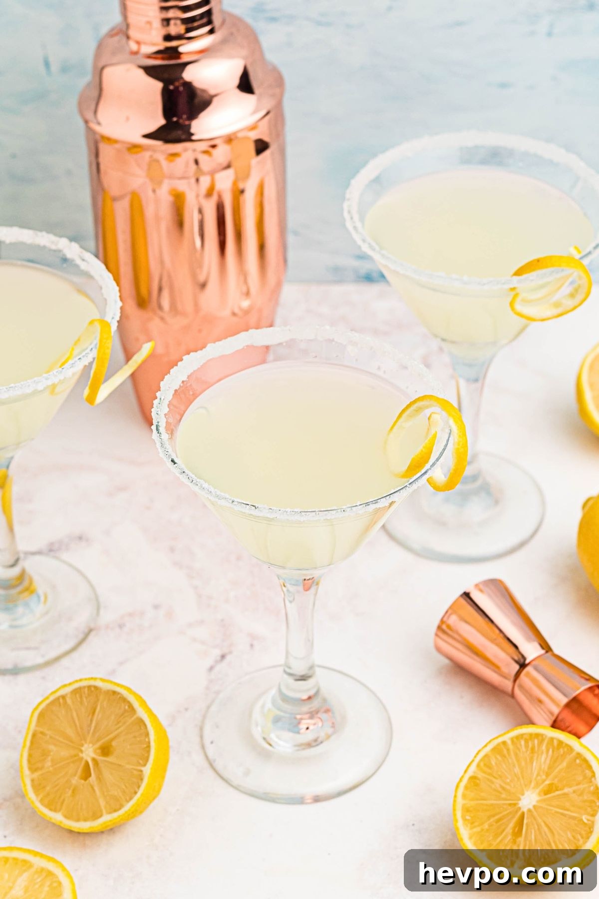 Citrus Lemon Drop Martini Recipe — Zesty Cocktail Guide 6 Lemon drop martinis on a marble board, surrounded by lemon slices.