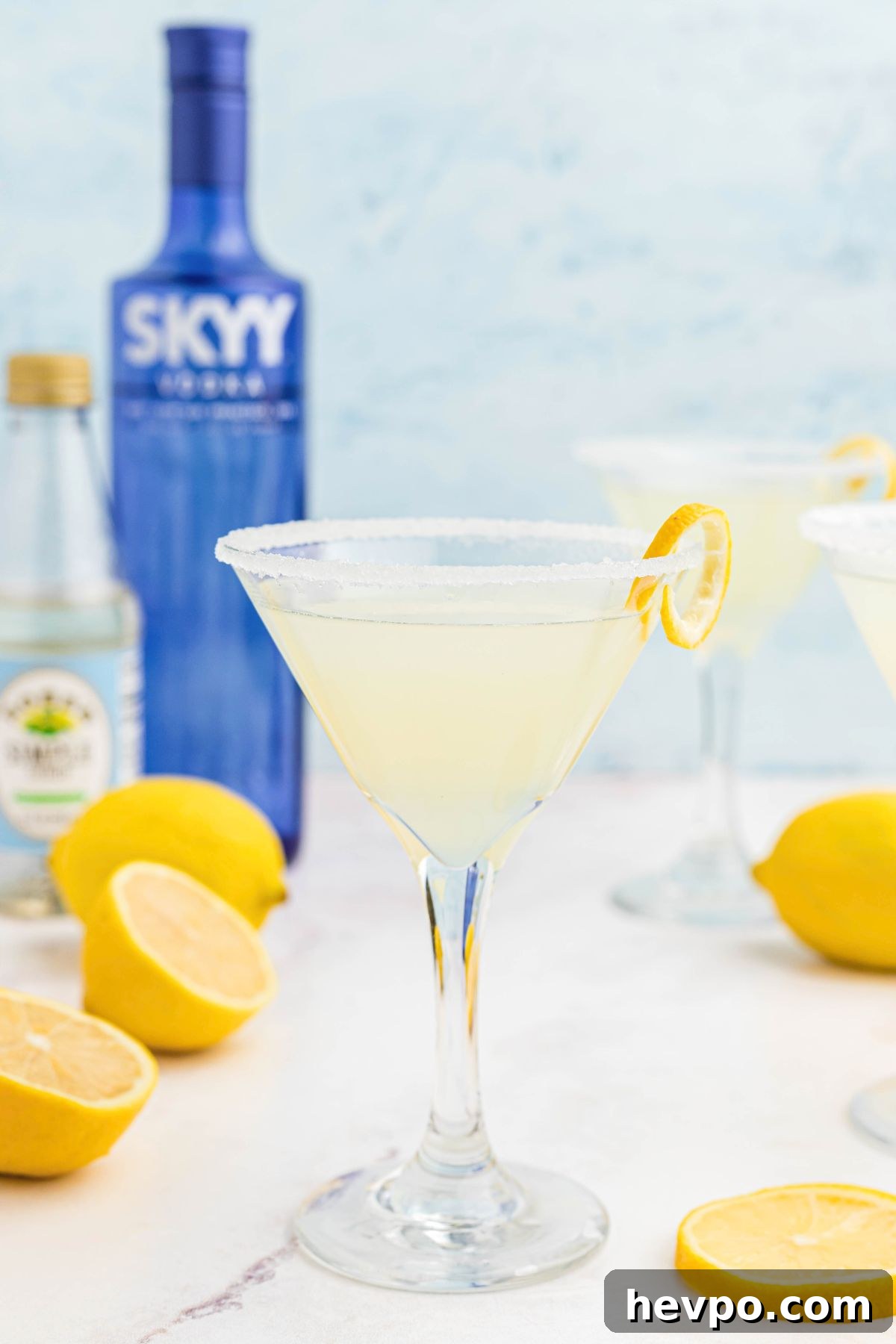 Citrus Lemon Drop Martini Recipe — Zesty Cocktail Guide 7 Lemon drop martini in a martini glass with a lemon curl for garnish.
