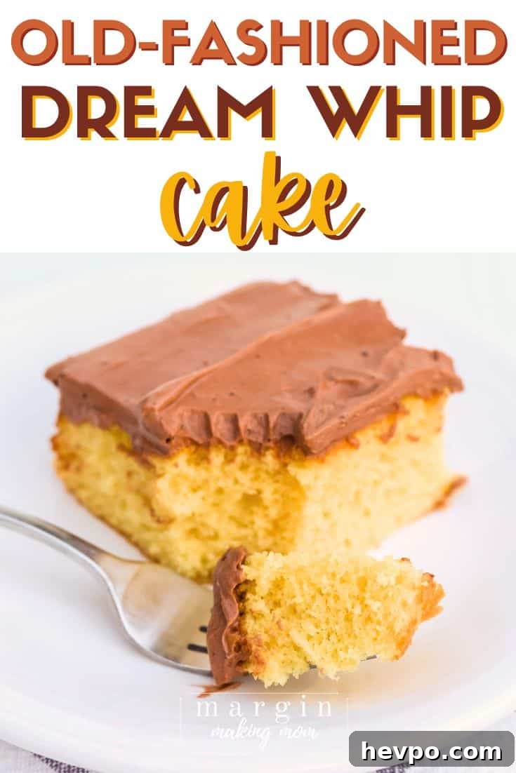 a fork holds a bite of yellow Dream Whip cake topped with chocolate pudding frosting, in front of the rest of the piece of cake.
