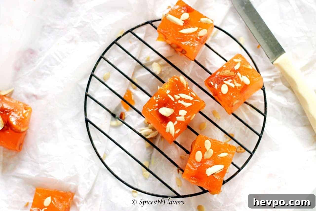 bombay karachi halwa squares placed on a circular wire rack with a butter knife on the side