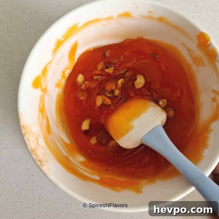 adding roasted cashewnuts to the halwa mixture