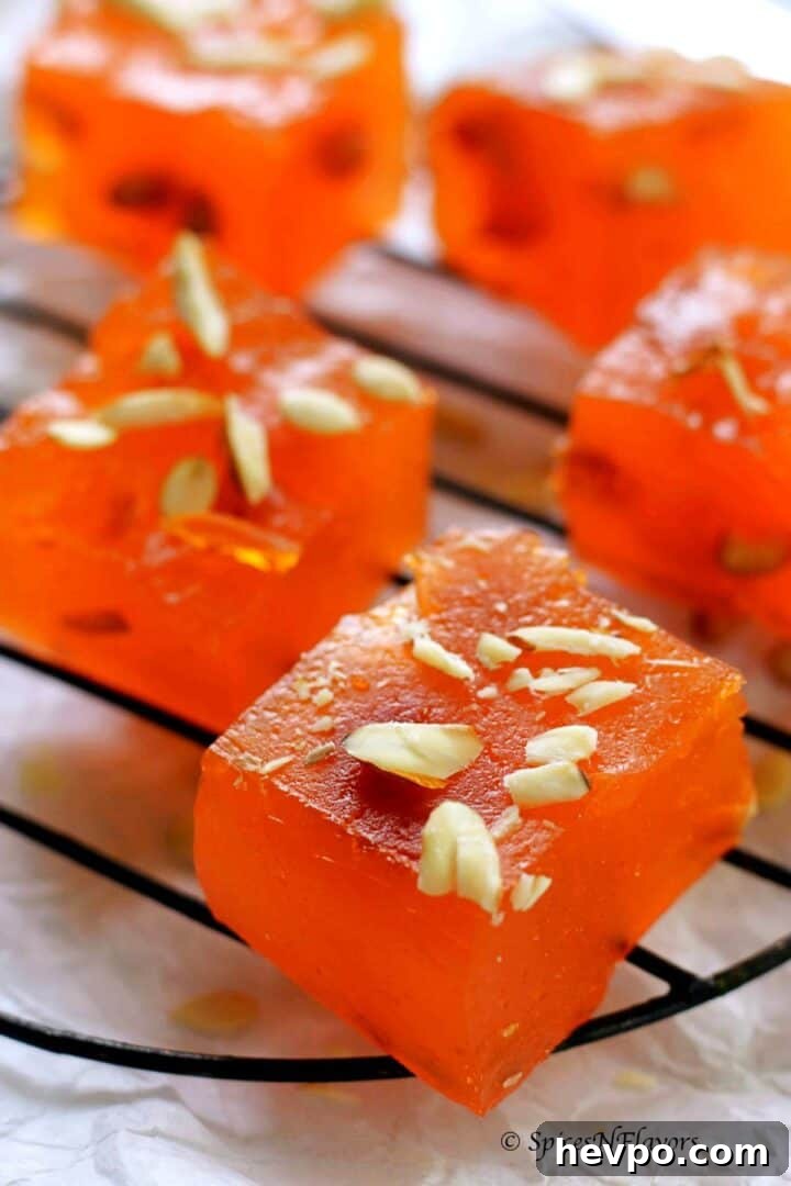 close up image of sliced halwa piece placed on a wire rack highlighting the height and width of the same