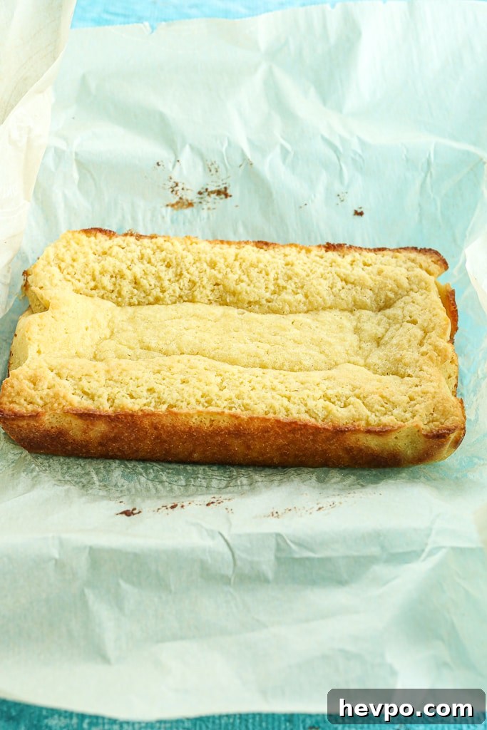 Keto Gluten-Free Sugar-Free Lemon Loaf Cake Recipe 9 cake removed from pan sitting on top of the parchment paper