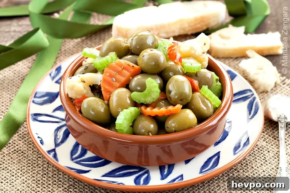 Cracked olive salad with vegetables in a small serving bowl.