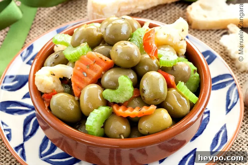 Close-up of Olive Schiacciate with green olives and chopped pickled vegetables.