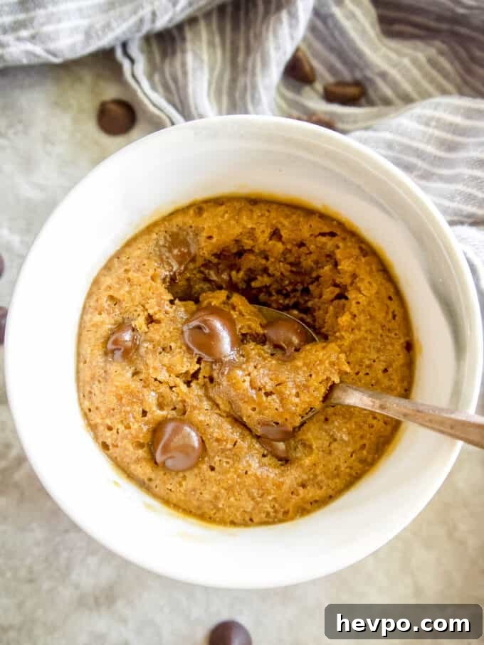 Mug cookie with a spoon in it.