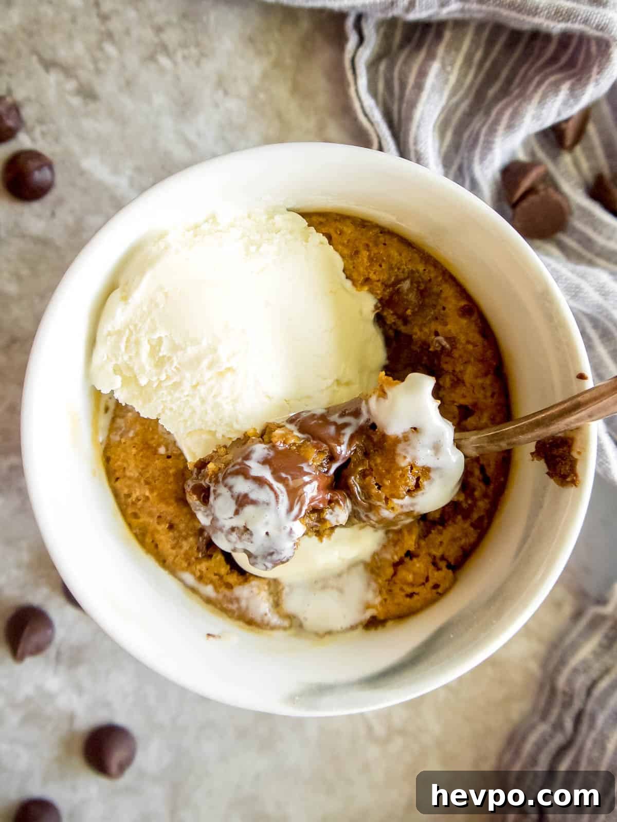 Healthy mug cookie with ice-cream on top.