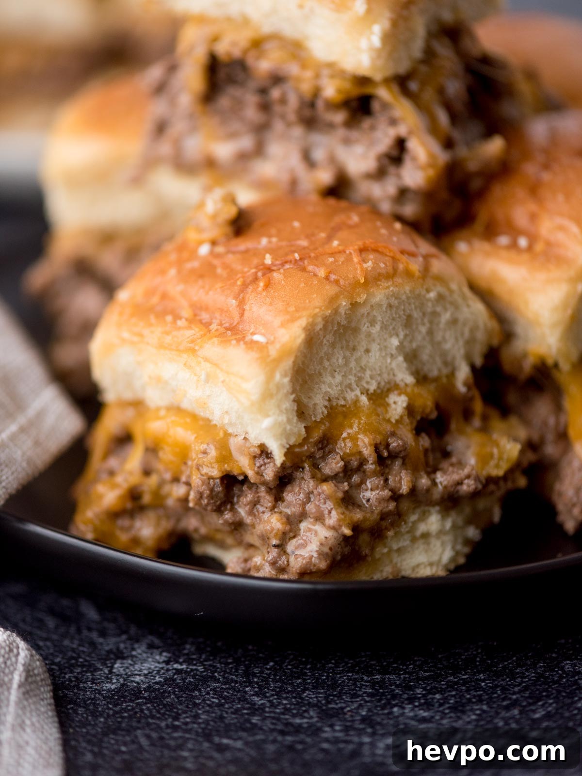 Hawaiian Roll Cheeseburger Sliders Recipe for Game Day 2 stack of cheeseburger sliders on a black plate