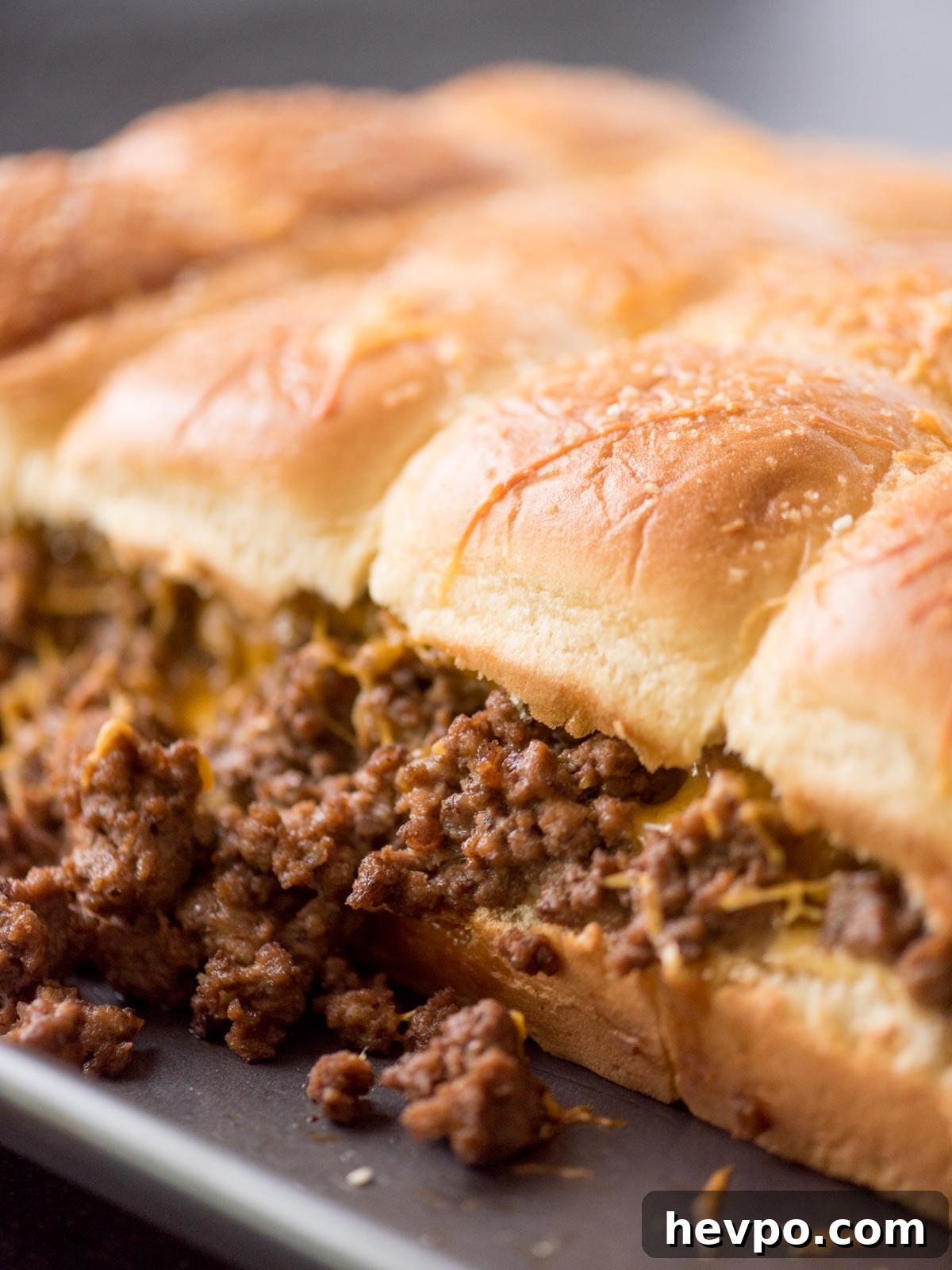 Hawaiian Roll Cheeseburger Sliders Recipe for Game Day 8 cheeseburger sliders on a baking sheet