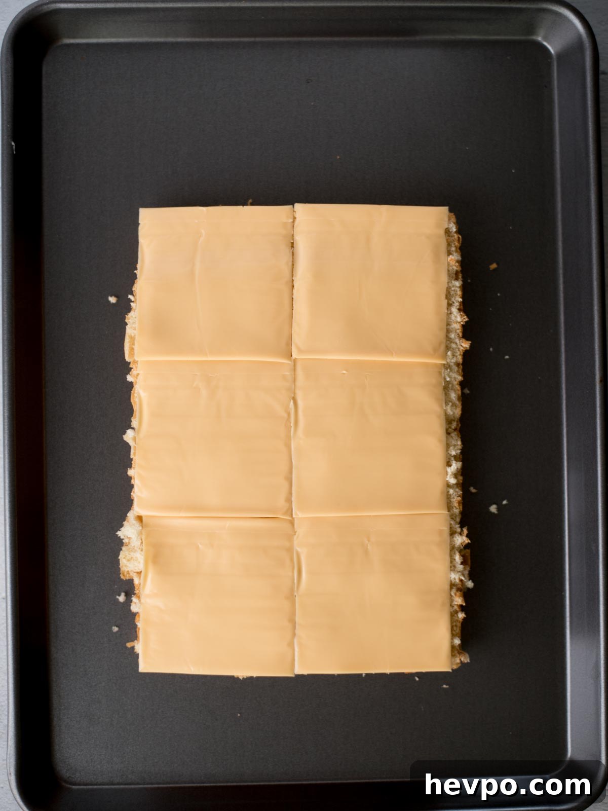 Hawaiian Roll Cheeseburger Sliders Recipe for Game Day 4 american cheese slices on top of the bottom half of hawaiian buns