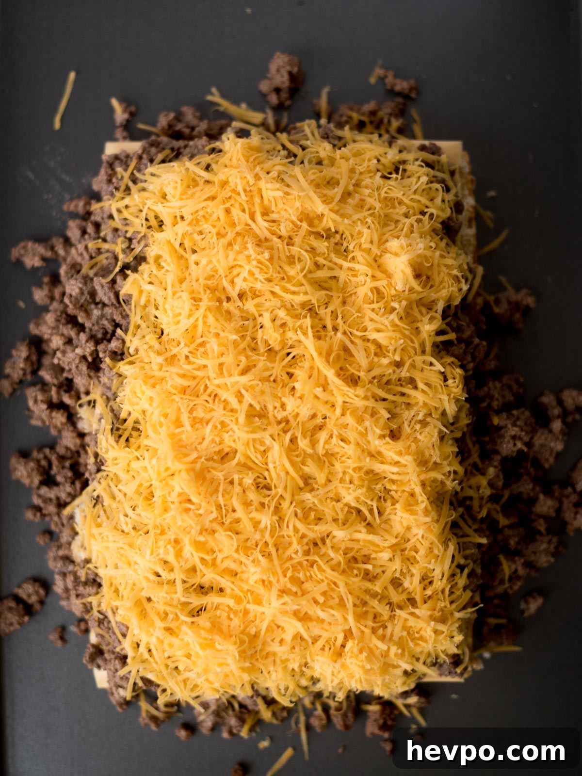 Hawaiian Roll Cheeseburger Sliders Recipe for Game Day 6 grated cheese on top of the ground beef mixture