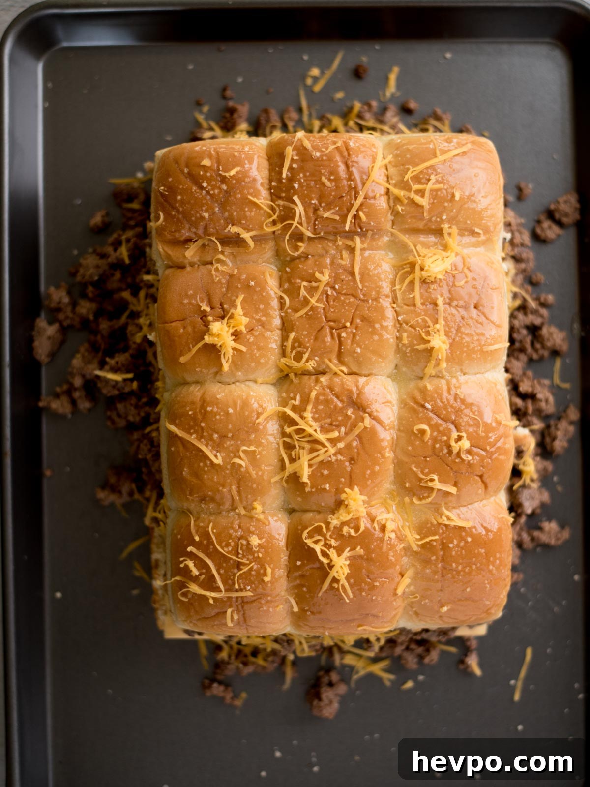 Hawaiian Roll Cheeseburger Sliders Recipe for Game Day 7 fully assembled sliders topped with cheese and garlic salt