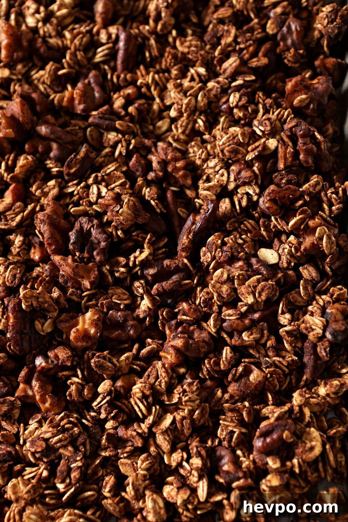 Baked granola on a sheet pan before cranberries are added
