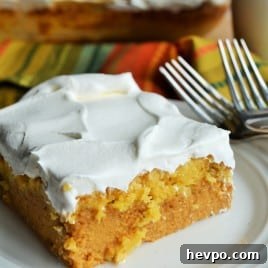 Pumpkin Crunch Cake | Pumpkin Crunch Cake is creamy pumpkin filling topped with a buttery, crunchy topping and covered in layers of sweet whipped topping. Perfection! | Pack Momma | https://www.awickedwhisk.com
