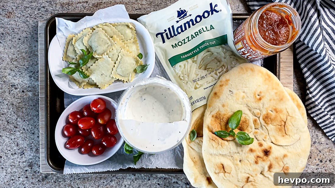 Ingredients for flatbread pizza arranged on baking sheet.