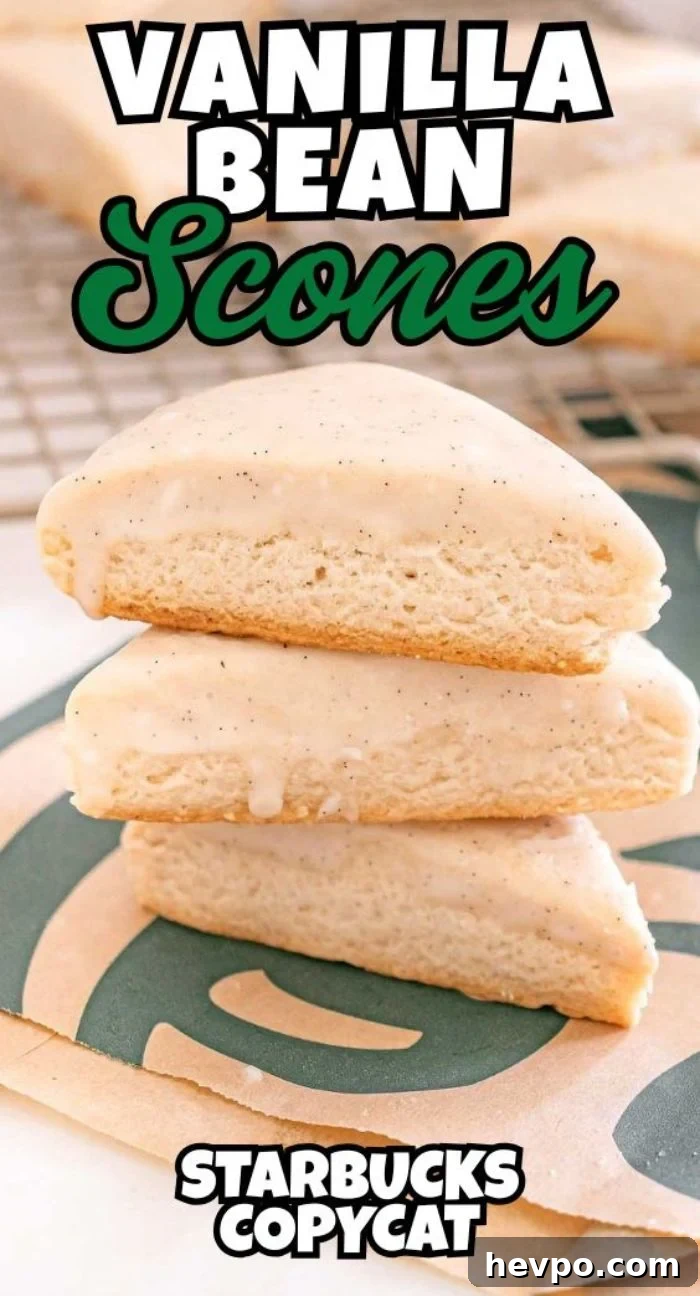 Three Starbucks Copycat Vanilla Bean Scones stacked on a Starbucks napkin, each topped with a luscious vanilla glaze.