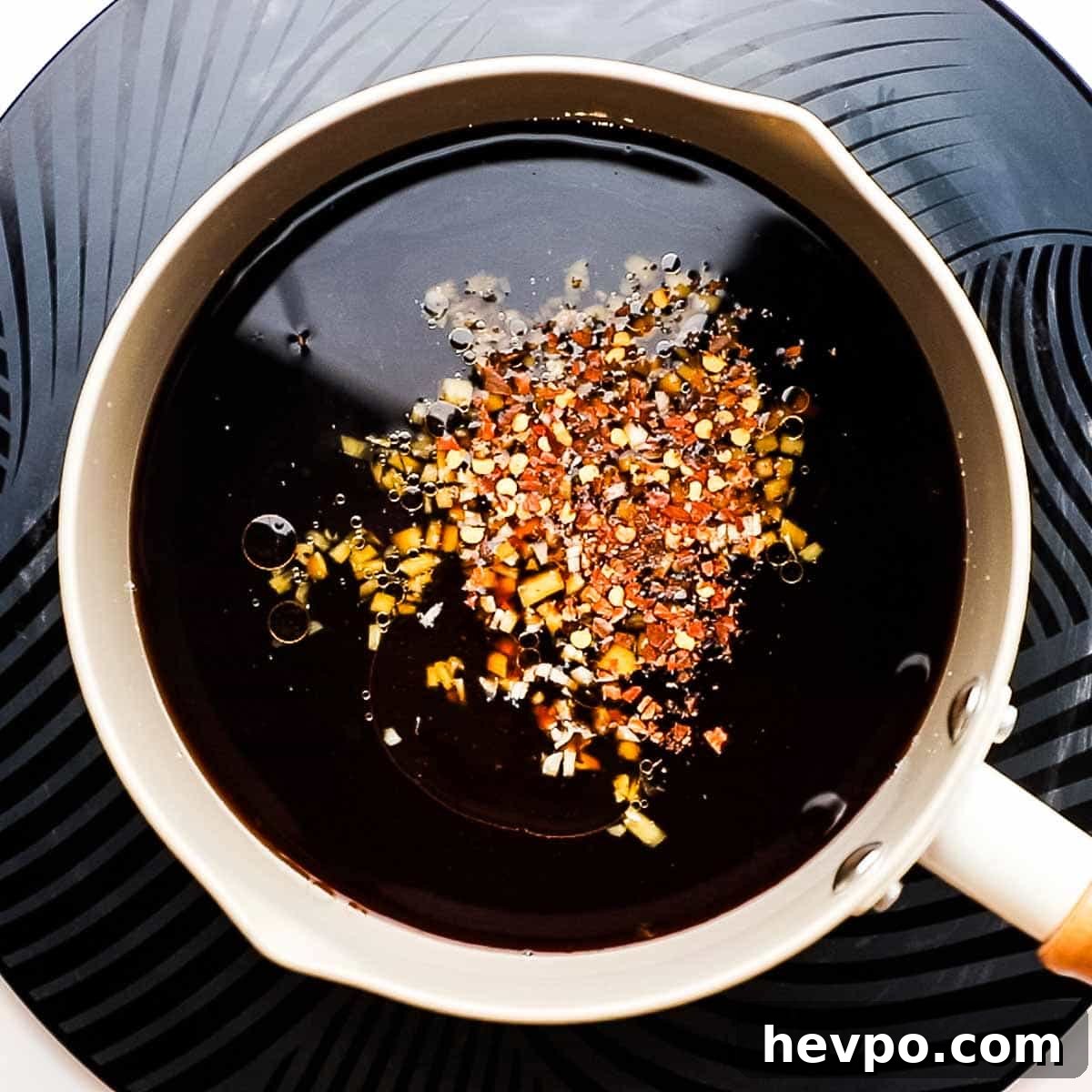 soy sauce, pineapple juice, brown sugar, rice vinegar, sesame oil, ginger, garlic, and red pepper flakes in a saucepan