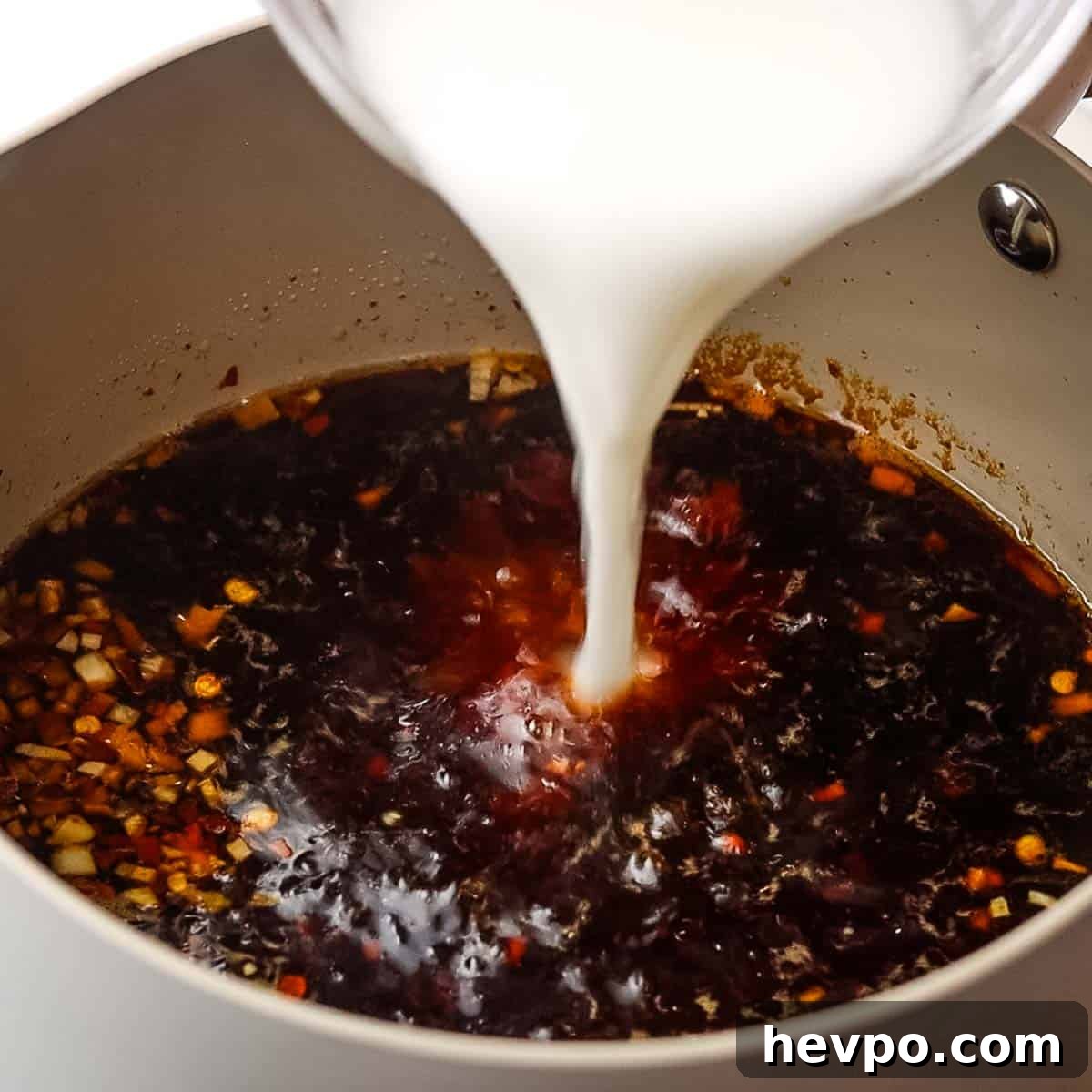 adding cornstarch slurry tot he simmering soy sauce mixture