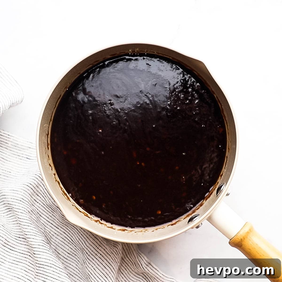 overhead view of a small saucepan with pineapple teriyaki sauce