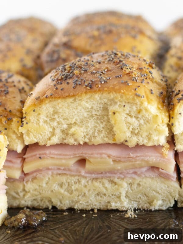 Serving brown sugar and ham sliders on a tray.