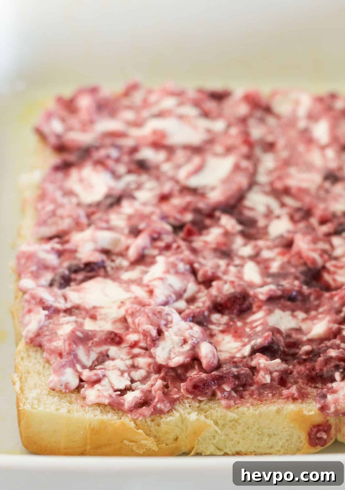 Turkey Cranberry Sliders with Herbed Cream Cheese Recipe 5 Adding the cranberry cream cheese mixture to rolls.