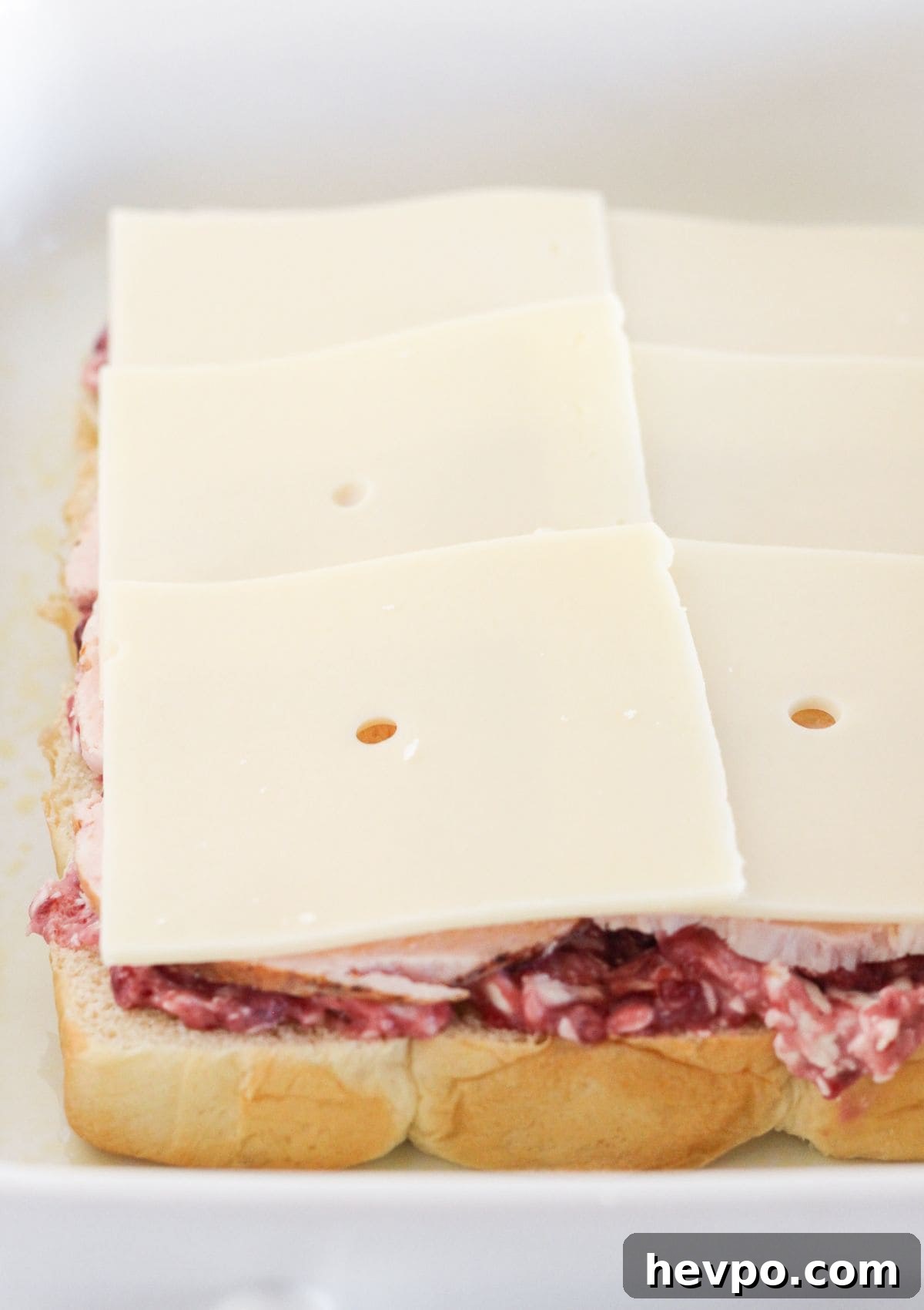 Turkey Cranberry Sliders with Herbed Cream Cheese Recipe 7 Topping the turkey with Swiss cheese.