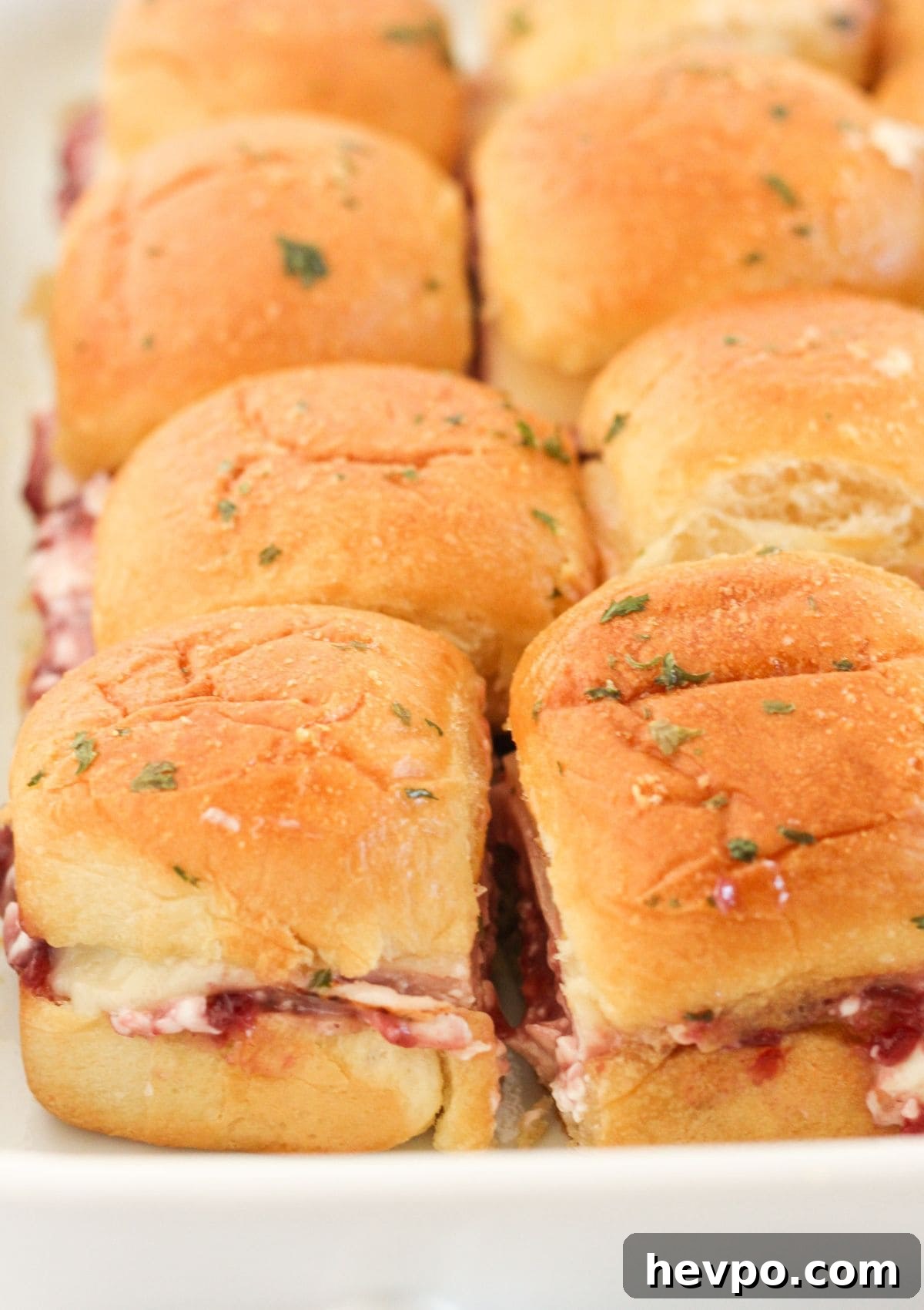 Turkey Cranberry Sliders with Herbed Cream Cheese Recipe 9 Baked turkey cranberry sliders cut into roll sized sandwiches.