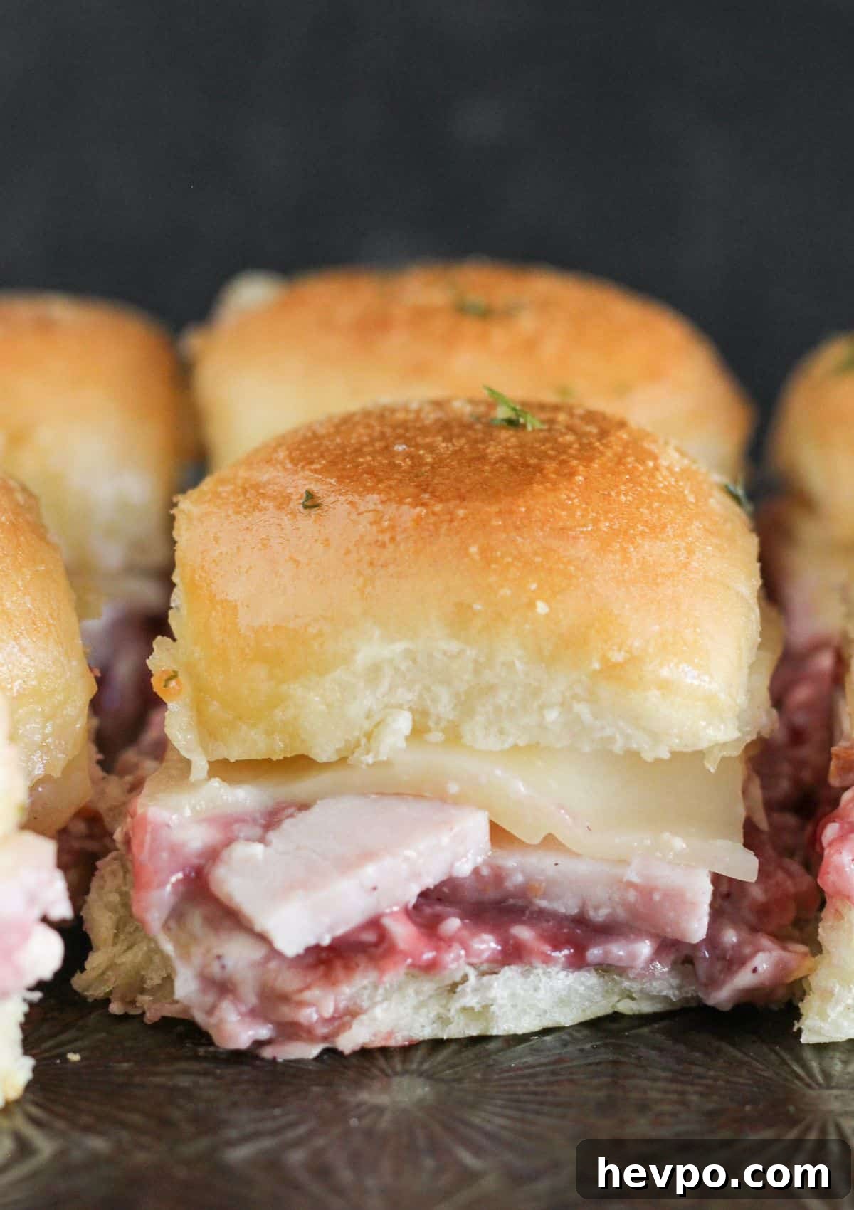 Turkey Cranberry Sliders with Herbed Cream Cheese Recipe 10 Turkey Cranberry Sliders on a tray.