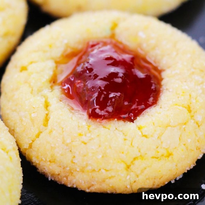Cake Mix Thumbprint Cookies with Jam Filling 7 close up of a lemon thumbprint cookie on black plate